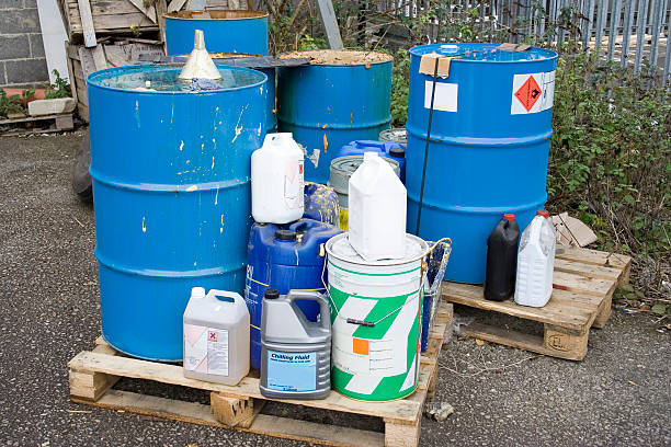 Industrial waste stored outside atop wooden pallets Hazardous industrial waste outside factory drum container stock pictures, royalty-free photos & images