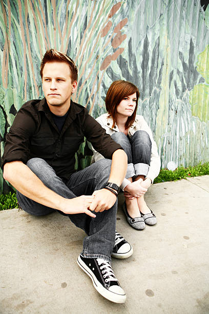 istock Two People Sitting in Front of Painted Wall 157165311