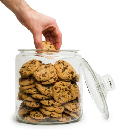 Glass storage jar for cookies isolated on white background