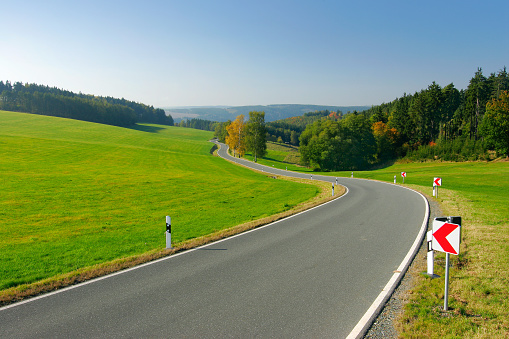 Road winding through fields and forests