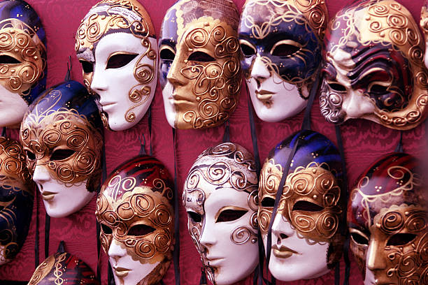 istock Bulk of venetian masks hanging in a row 157165418
