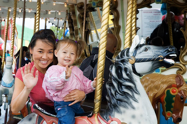 istock Mother and Daughter on Carousel 157165634