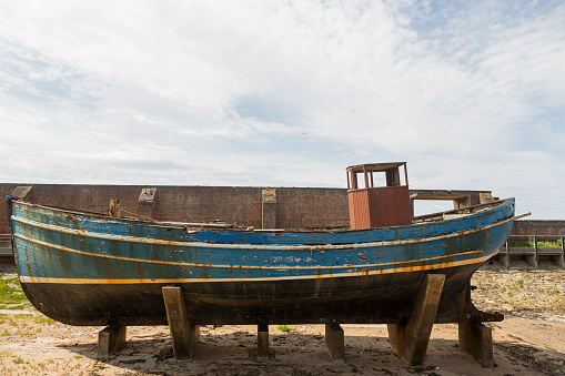 wooden fishing boat at coast of ocean beach on ayrshire at firth of clyde glasgow england scotland UK