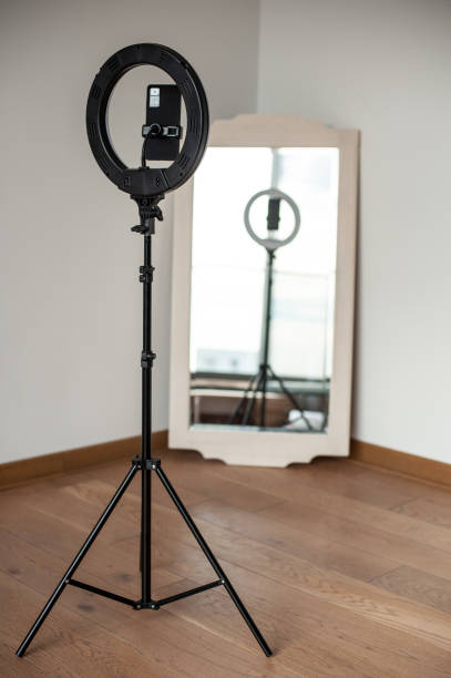 Selfie LED ring light with smartphone. Blogging equipment. Studio background.