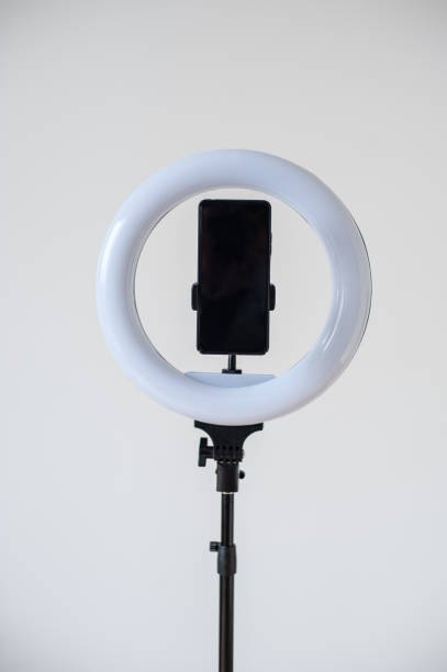 istock Selfie LED ring light with smartphone. Blogging equipment. Studio background. 1571670676