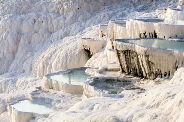 Photo of White travertine limestone rock formations known as the cotton castle, Pamukkale, Denizli, Anatolia, Turkey, Asia Minor, Asia