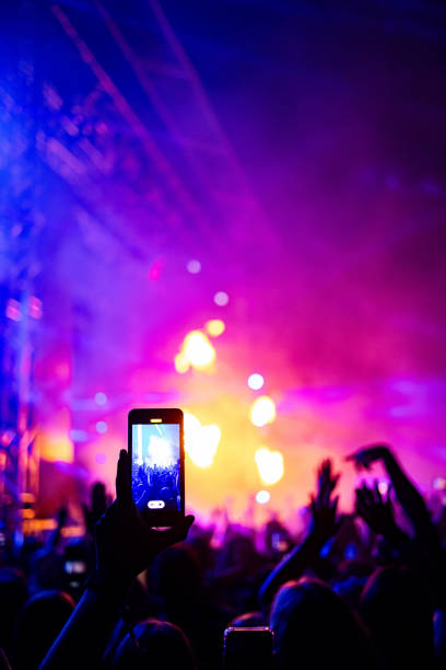 istock Recording a live concert with cell phone! 1571674942