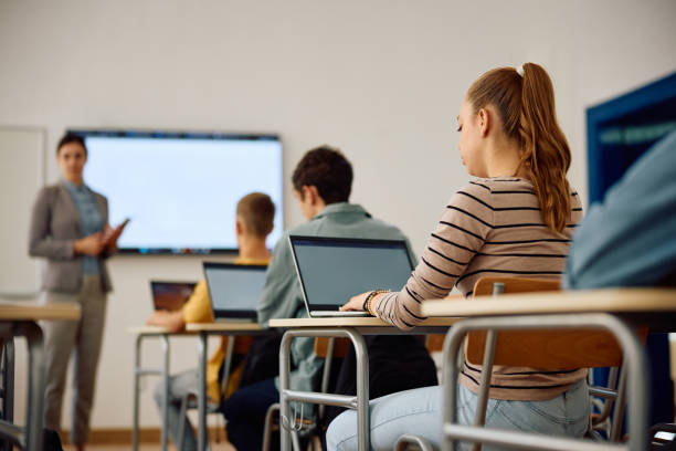 istock High school student and her classmates attending computer class in the classroom. 1571675480