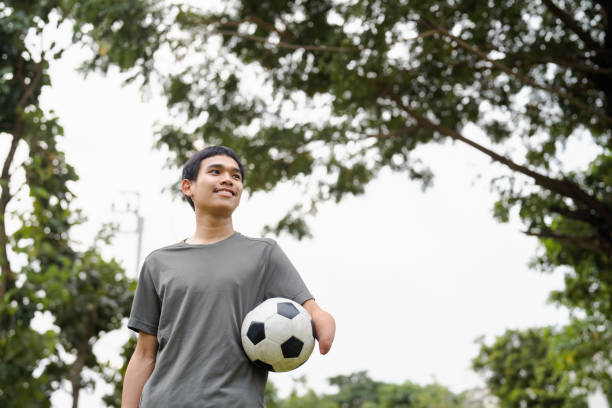 istock Handicapped man exercise at a public park. 1571680282