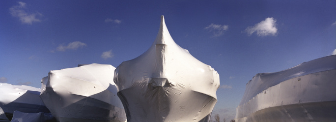 winter storage for the yachts,all covered in plastic wraps and mounted on the stands