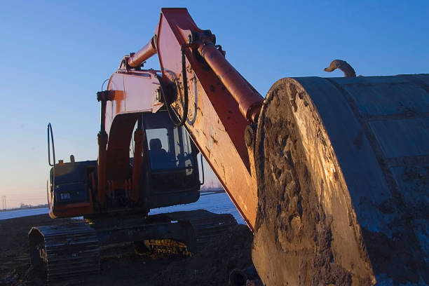 Power Shovel Glows at End of Day Twilight  road scraper stock pictures, royalty-free photos & images