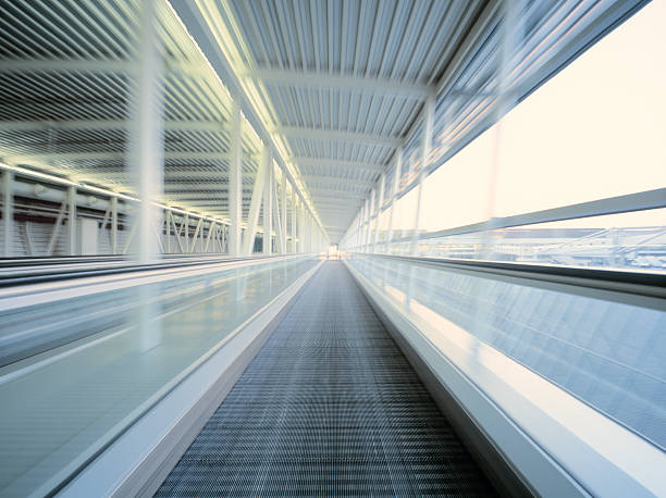 Walkway Moving (motion blur) walkway at airport. High-end scan of 6x7cm transparency. airport travelator stock pictures, royalty-free photos & images