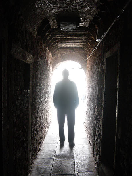 istock Silhouette of Man in Dark Tunnel with Light at End 157168380