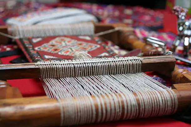small handloom with carpet, shallow depth of field, focus on the threads