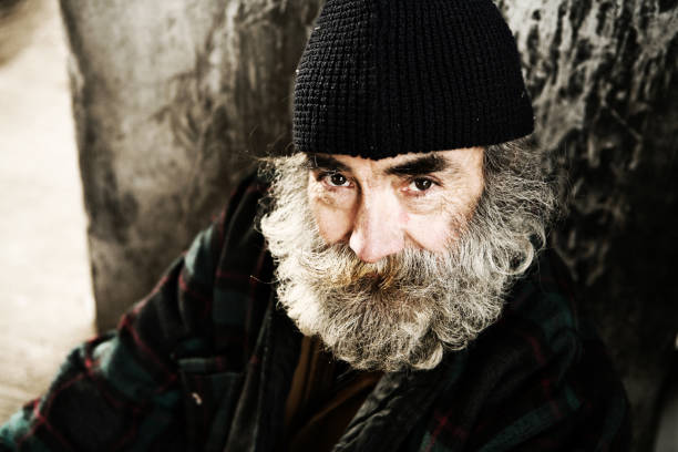 istock Older Homeless Male Sitting Against a Tree 157168863