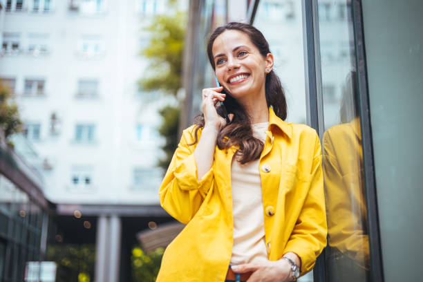 istock Young latin woman talking on mobile phone and looking away. 1571692219