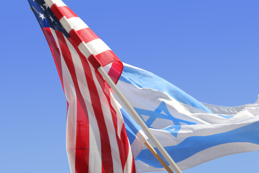 An Israeli flag flies from a balcony in Safed, Israel