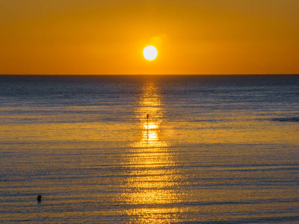 istock Sunrise over the ocean with clouds 1571701432