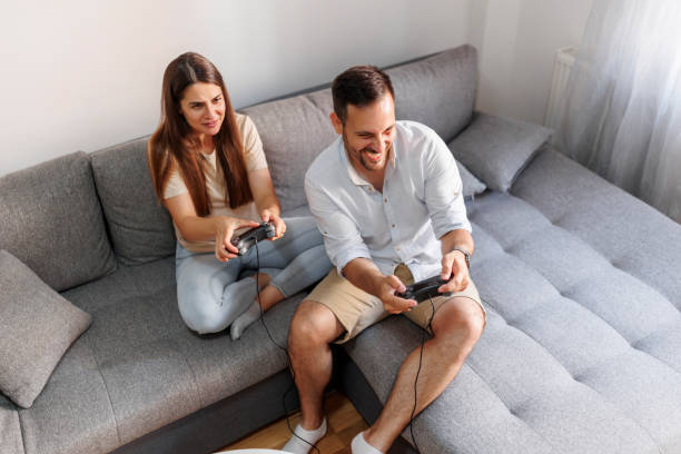istock Couple having fun playing video games 1571701545