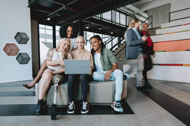 Group of coworkers looking at laptop