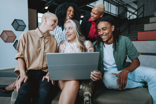 istock Group of coworkers looking at laptop 1571703668
