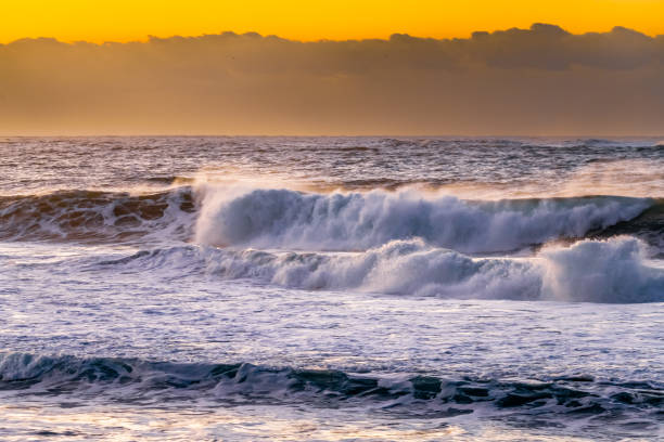 istock Sunrise and waves at the seaside 1571703681