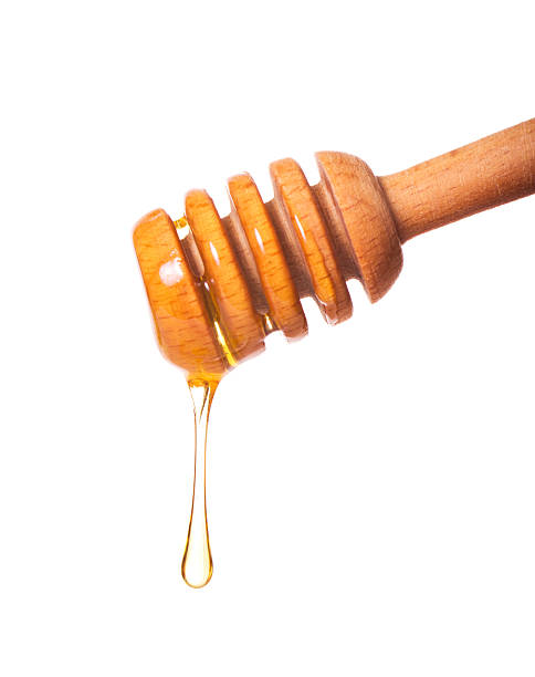 istock Honey dripping from a wooden dipper 157173583
