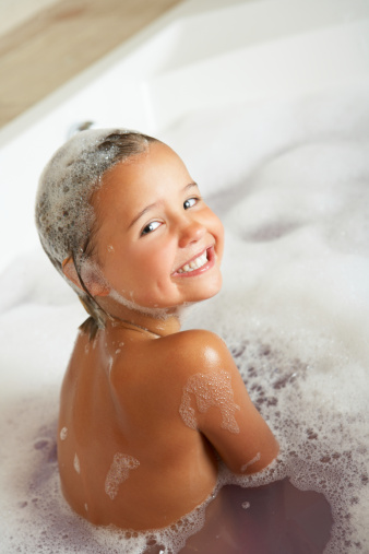Girl Playing In Bath Smiling To Camera