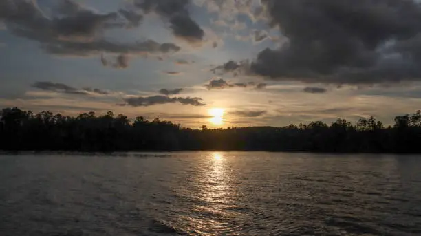 Lots of clouds swarm the sun as it sinks for another evening on beautiful Lake Sinclair in Milledgeville, Georgia.