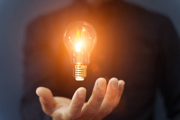 istock Knowledge idea bulb concept. Electric light bulb in hand business manager. Innovation, brain, creative concept 1571743664