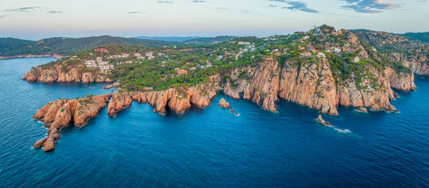 Panoramic aerial view of rock cliff and caves in Cap de Begur, Aigua xelida and Tamariu beach early in the morning, Costa Brava, Calonia, Spain