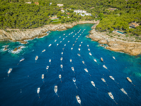 aerial view of small fishing and recreational boats moored on the shore in Aiguafreda Beach, Begur Coast, Costa Brava, Catalonia, Spain