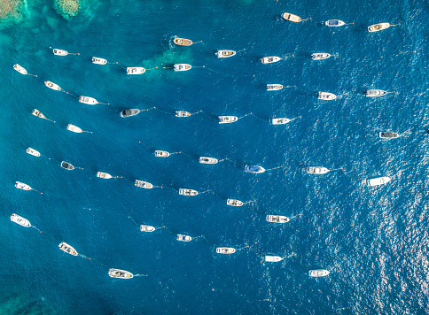 zenithal aerial view of small fishing and recreational boats moored on the shore.