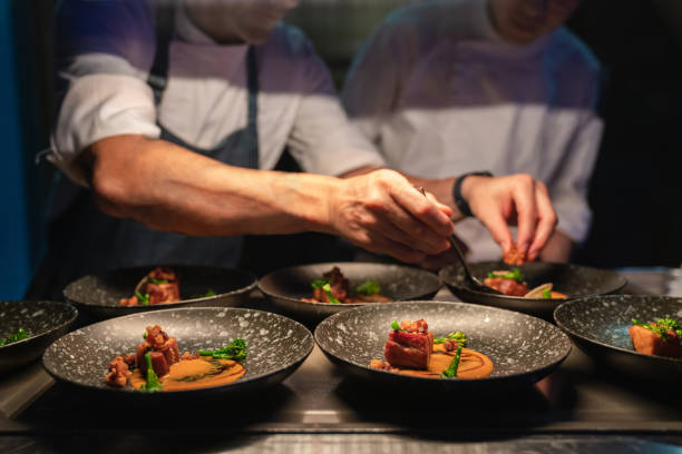 istock Chefs preparing food in professional kitchen. 1571755572