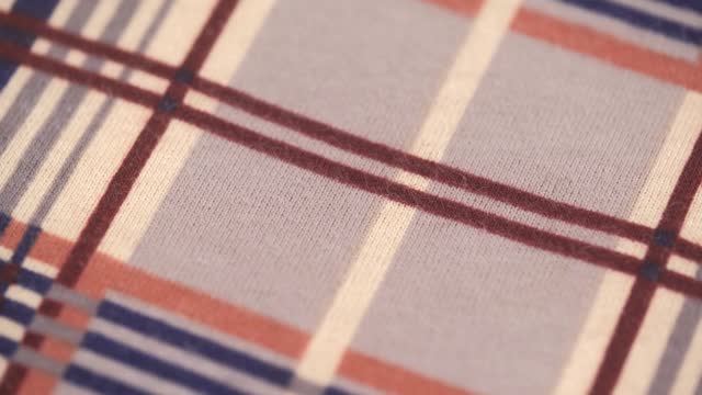 closeup of soft flannel fabric with checkered stripe pattern. macro shooting. rotation.