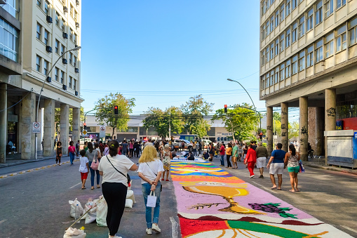 Niteroi, Rio de Janeiro, Brazil - June 8, 2023: People walking by a sand carpet in a city street. Street scene of the Sao Goncalo Annual Festival Of Sand Carpets. The religious event is a tradition and a tourist attraction.