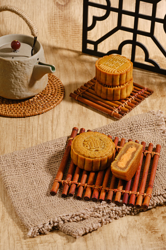 Moon Cake Mid Autumn Festival with teapot on wooden background ,chinese style photograp