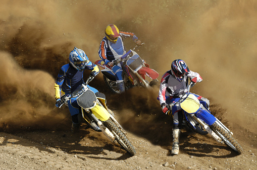 An Enduro bike racer riding on a dirt motocross road