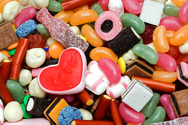 Candy for Valentine Colorful candy with a heart-shaped one in the middle. In aRGB color for beautiful prints.  candy jellybean variation color image stock pictures, royalty-free photos & images