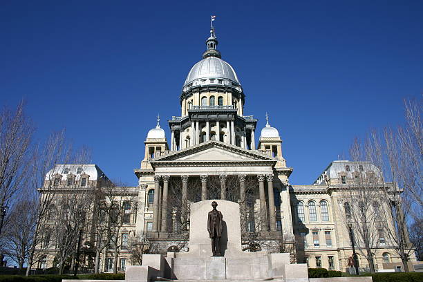 Outside view of the Illinois State Capitol Building Illinois State Capitol Building with Abraham Lincoln statue and a clear blue sky. springfield illinois stock pictures, royalty-free photos & images