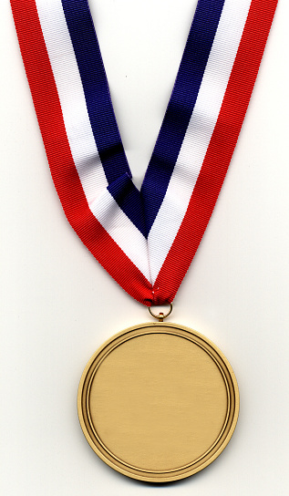 Gold medal with multicolored ribbon on blue background, copy space for text.