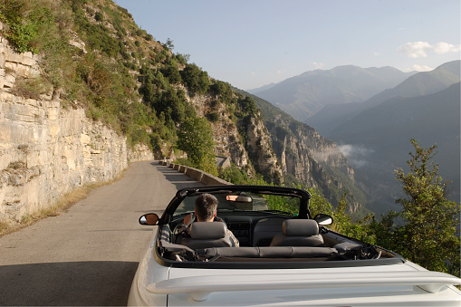 A ride in a convertible down a narrow, windy road in the French Alpes-Maritimes. This is on the D56, very close to the end of the road at Bairols. It's only 30 minutes or so to Nice on the Cote d'Azur (French Riviera). The shot was taken on an early summer morning.