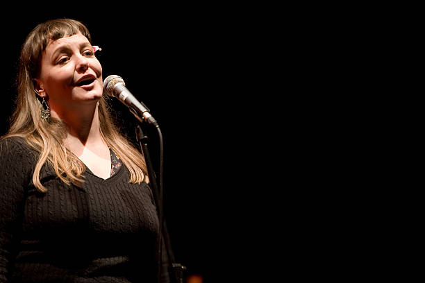 istock Singer in the spot light at the microphone 157180424