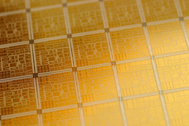 Close-up view of chip wafer with regular pattern in gold stock photo