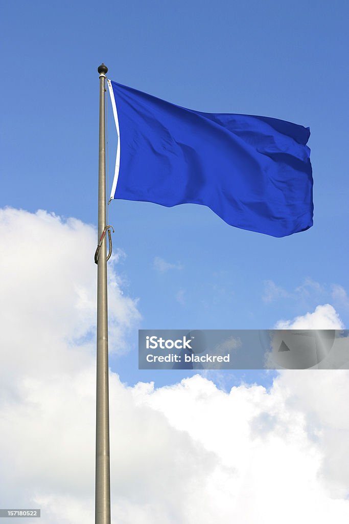 Blue Flag Blank blue flag, against sunny blue sky. Flag Stock Photo