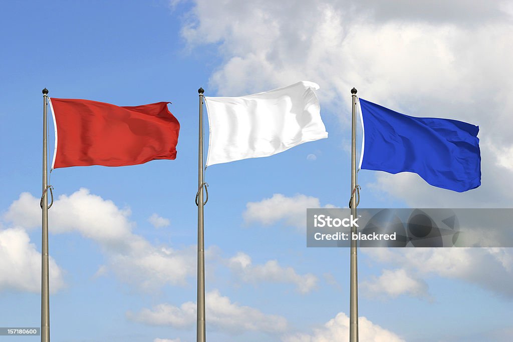 Red White Blue Red, white and blue flags, against sunny blue sky. Flag Stock Photo