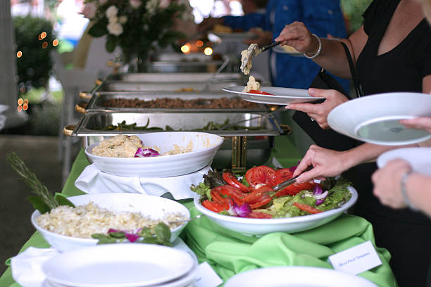 istock Group of people helping themselves to a buffet 157180693