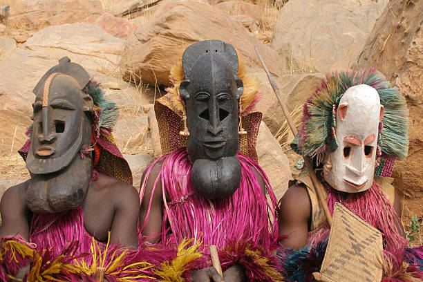 Dogon Masked Dancers -- three human masks Dogon Masked Dancers  in Irelli, Mali, west Africa. mali stock pictures, royalty-free photos & images