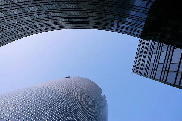 Image of modern office buildings against blue sky.
