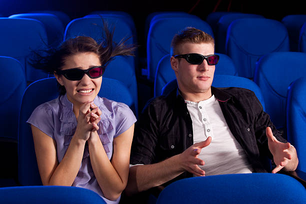 Arts and entertainment in theatre, with man and woman looking at stage with red curtains